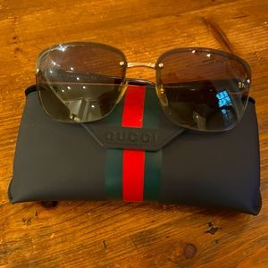 Gucci women’s sunglasses with classic gold logo on sides